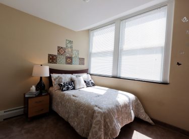 Amenities include bed, dresser, mirror, night stand