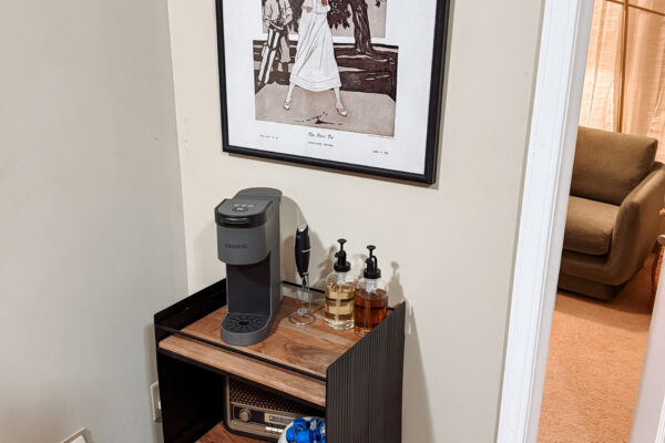We offer fully furnished housing units Bar stand with a coffee machine and artwork above on the wall